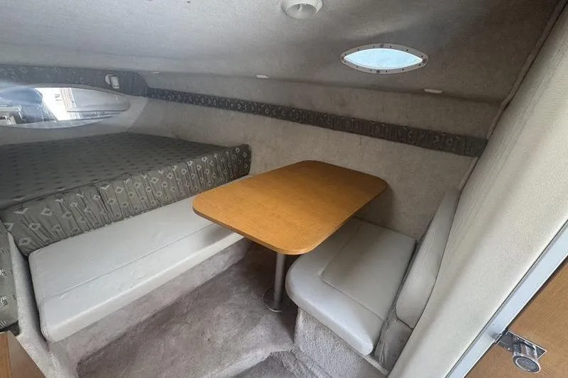 Slide: The Image of Cozy interior of 2000 Weldcraft 26 Martinque with bed and dining area. - 19