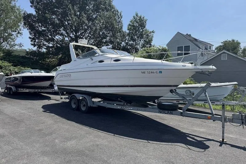 Slide: The Image of 2000 Weldcraft 26 Martinque boat on trailer, parked outdoors. - 2