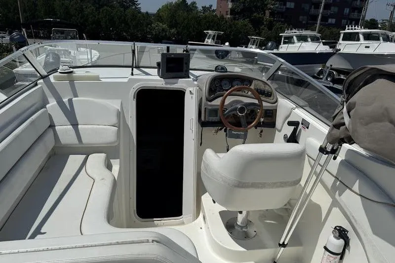 Slide: The Image of 2000 Weldcraft 26 Martinque boat interior with steering wheel and seating area. - 20