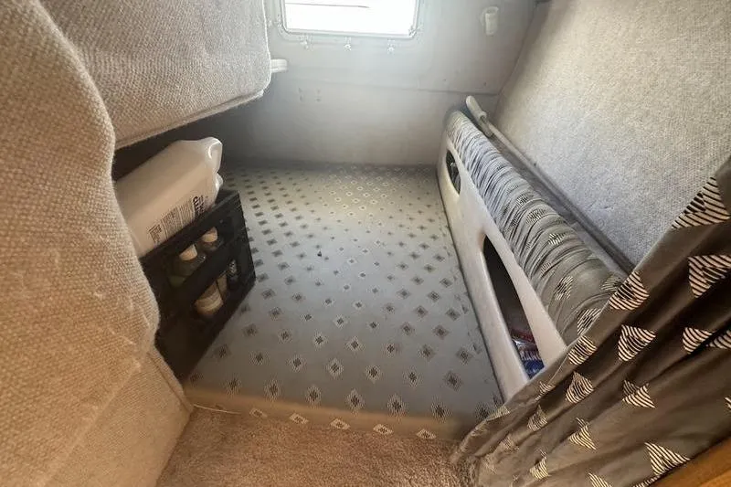 Slide: The Image of Interior cabin of 2000 Weldcraft 26 Martinque boat with patterned flooring and storage. - 22