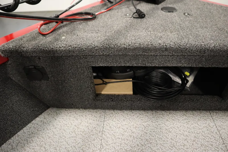 Slide: The Image of Storage compartment in 2026 Crestliner 1750 Hawk Walkthrough boat, featuring coiled cables. - 14