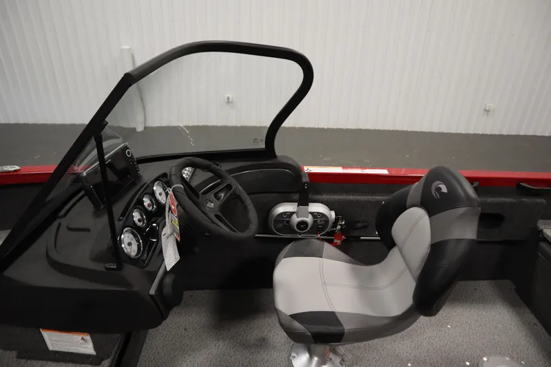 Slide: The Image of 2026 Crestliner 1750 Hawk Walkthrough boat interior with steering wheel and seat. - 19