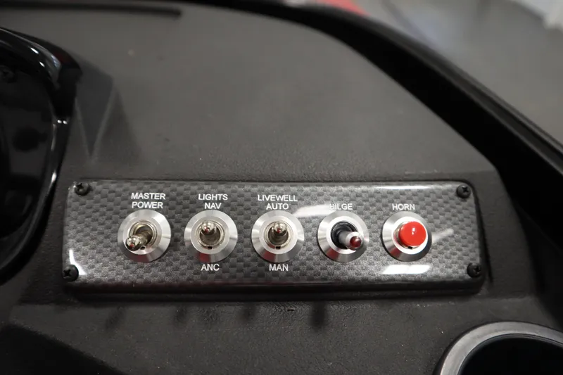 Slide: The Image of Control panel of 2026 Crestliner 1750 Hawk Walkthrough boat with switches and buttons. - 24