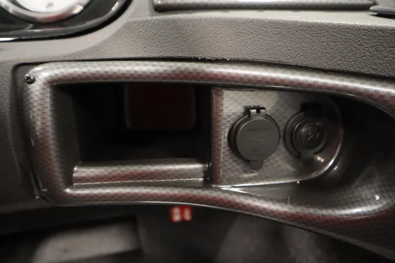 Slide: The Image of Dashboard of 2026 Crestliner 1750 Hawk Walkthrough with power outlets and carbon fiber finish. - 27