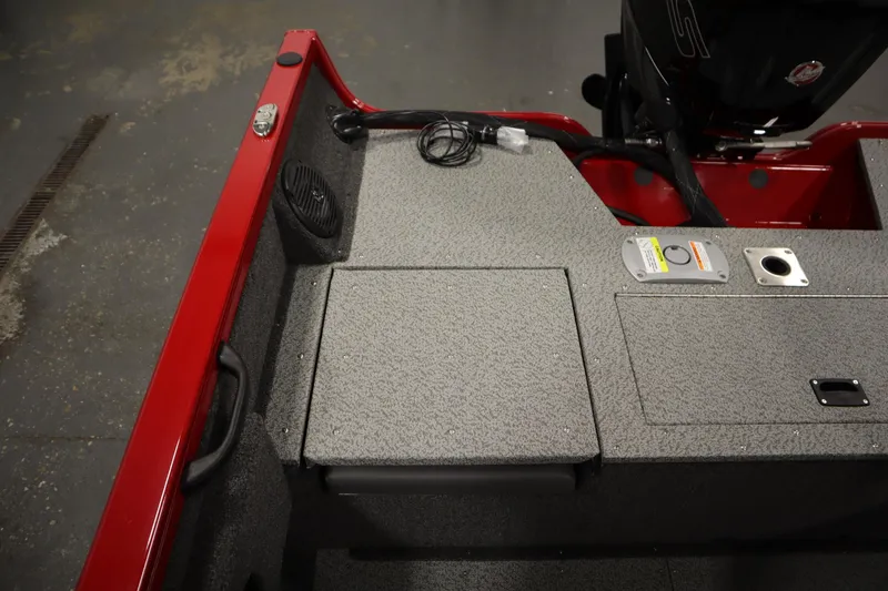 Slide: The Image of 2026 Crestliner 1750 Hawk Walkthrough boat interior with red trim and storage compartments. - 35