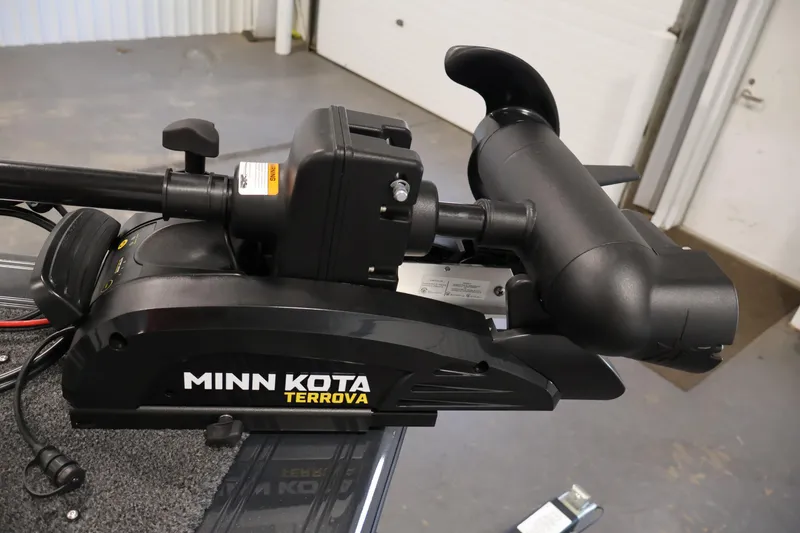 Slide: The Image of 2026 Crestliner 1750 Super Hawk boat in a garage, featuring a Mercury 115 outboard motor. - 12