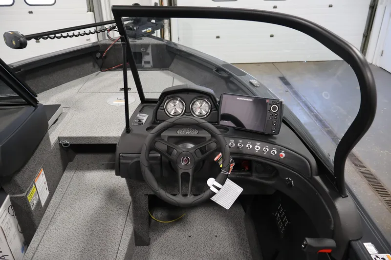 Slide: The Image of Storage compartment in 2026 Crestliner 1750 Super Hawk boat, featuring Minn Kota foot pedal. - 16