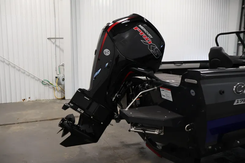 Slide: The Image of 2026 Crestliner 1750 Super Hawk boat storage compartment with carpeted interior and cup holders. - 28