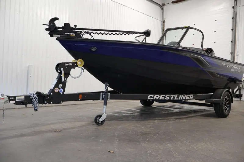 Slide: The Image of 2026 Crestliner 1750 Super Hawk boat interior with cushioned seating and motor. - 31