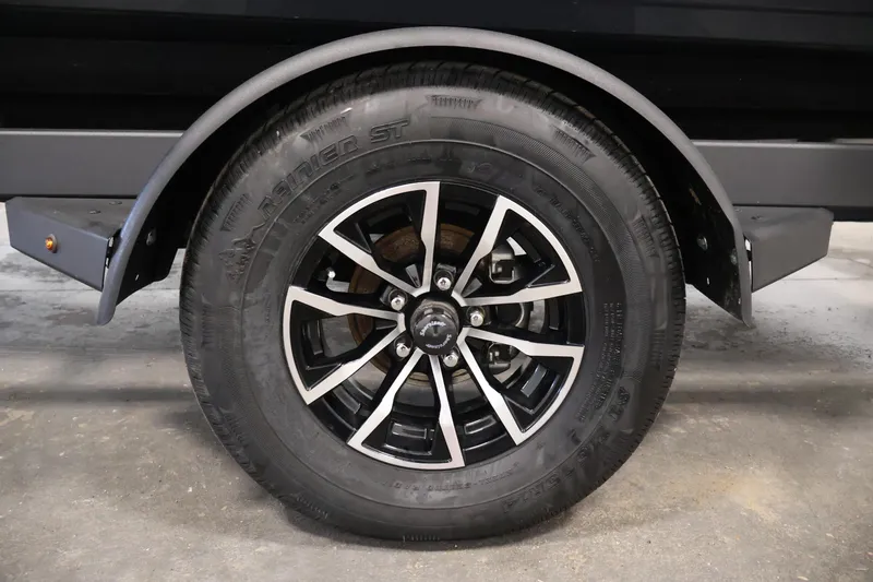 Slide: The Image of 2026 Crestliner 1750 Super Hawk boat interior with carpeted deck and storage compartments. - 32