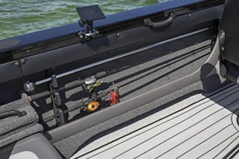 Slide: The Image of 2026 Crestliner 1750 Super Hawk interior with fishing rod storage and lake view. - 8