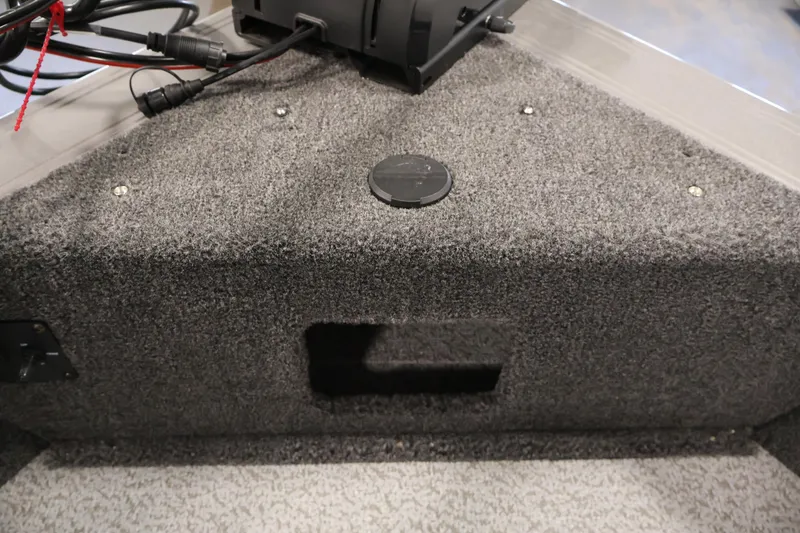 Slide: The Image of Interior view of 2026 Crestliner 1850 Super Hawk boat, featuring carpeted storage area. - 13