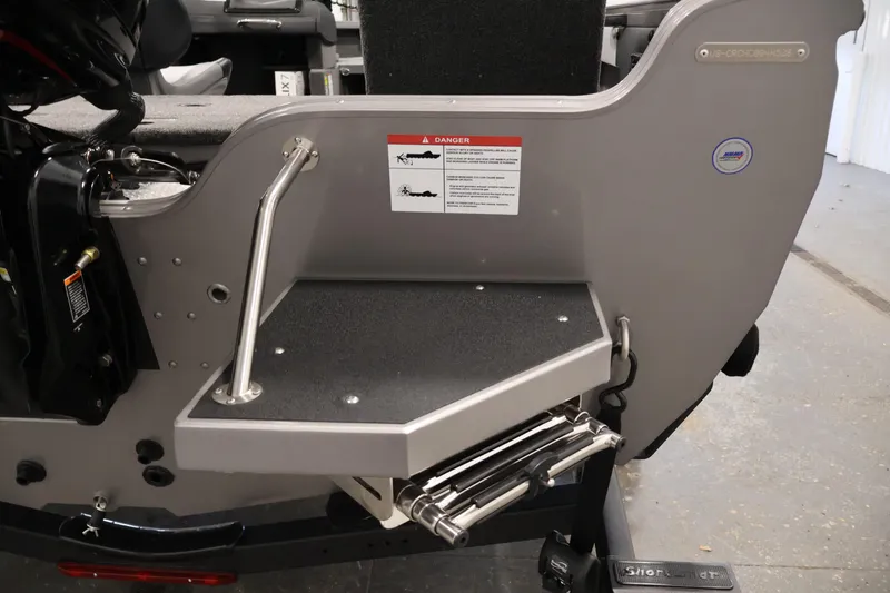 Slide: The Image of 2026 Crestliner 1850 Super Hawk boat with swim platform and safety warning label. - 29