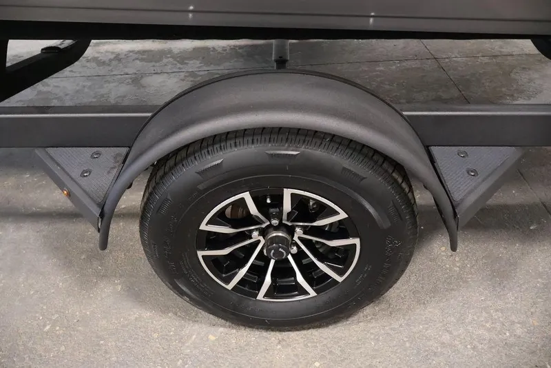 Slide: The Image of Trailer wheel of 2026 Crestliner 1850 Super Hawk boat, featuring black alloy rim. - 39