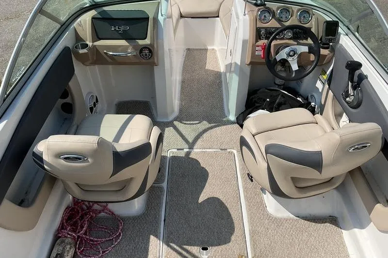 Slide: The Image of Interior of a 2013 Chaparral H2O Fish & Ski boat with beige seating and dashboard. - 11