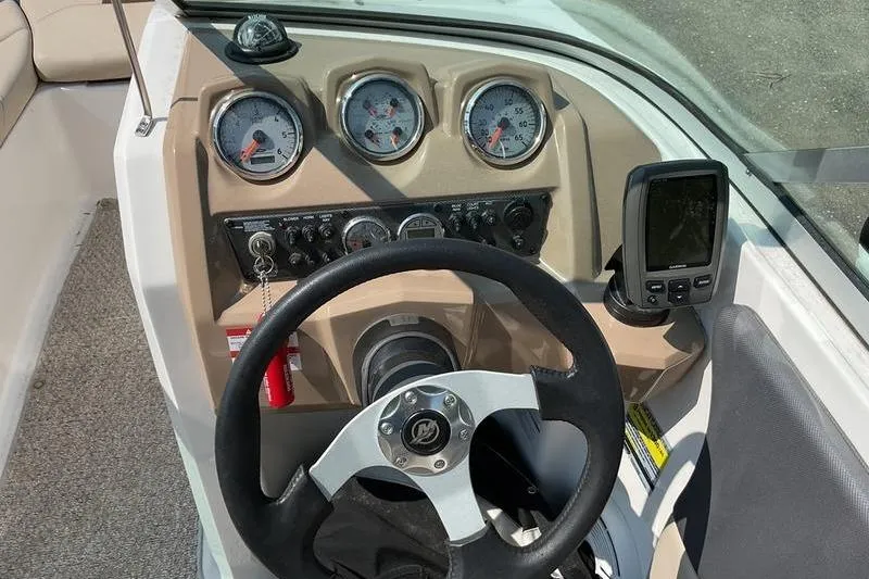 Slide: The Image of 2013 Chaparral H2O Fish & Ski dashboard with steering wheel, gauges, and navigation system. - 3
