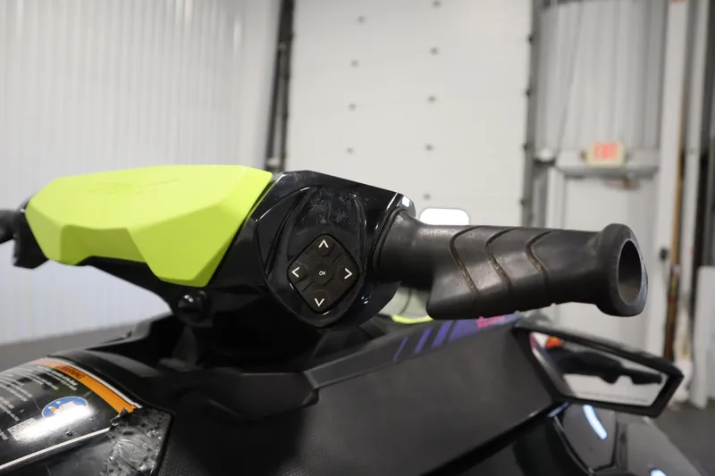 Slide: The Image of Close-up of 2020 Sea-Doo Wake Pro 230 handlebar controls in a garage setting. - 14