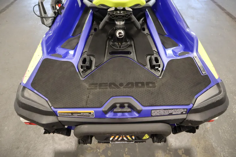 Slide: The Image of 2020 Sea-Doo Wake Pro 230, rear view, blue and black design, in a garage setting. - 22