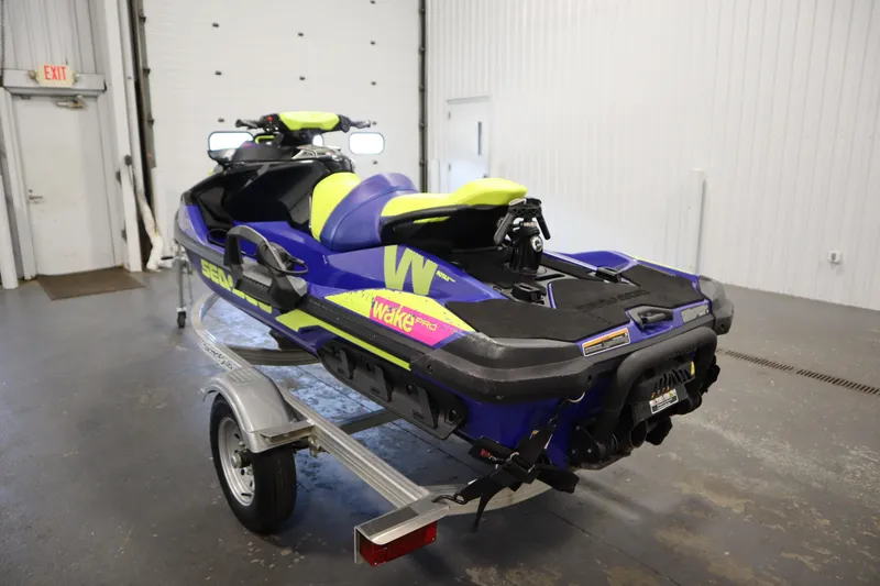 Slide: The Image of 2020 Sea-Doo Wake Pro 230 jet ski on trailer in garage setting. - 7