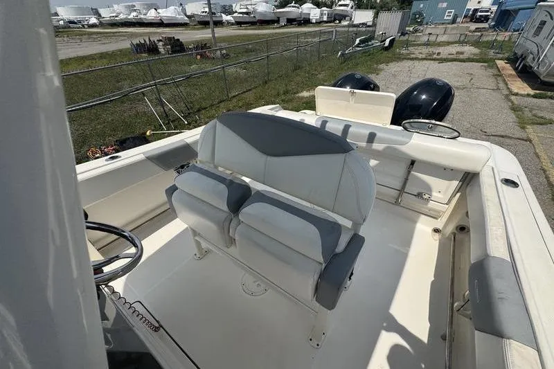 Slide: The Image of 2021 Robalo R242 boat interior with dual seats and steering wheel. - 10