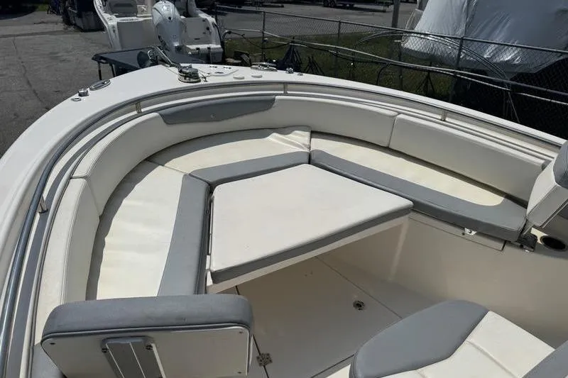 Slide: The Image of 2021 Robalo R242 boat interior with cushioned seating and spacious deck area. - 4