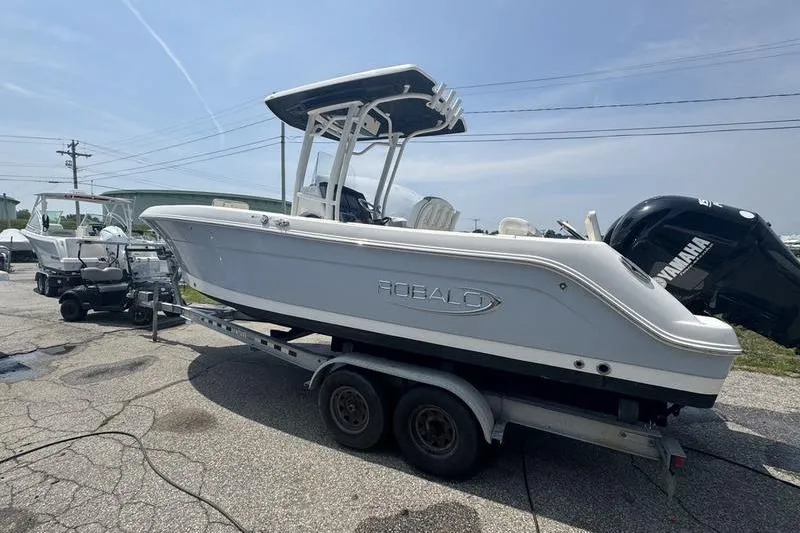 Slide: The Image of 2021 Robalo R242 boat on trailer, featuring Yamaha outboard motor. - 7