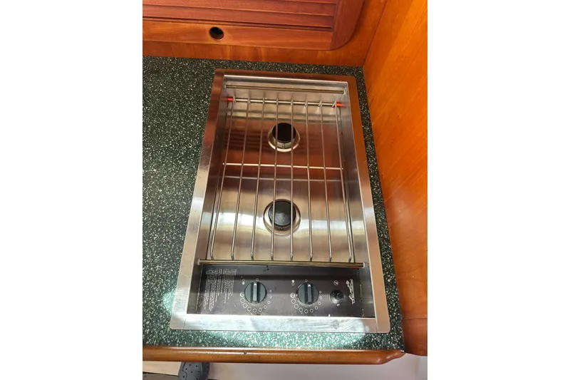 Slide: The Image of Stainless steel stove on 2000 Hinckley Picnic Boat 36 with wooden cabinetry. - 18