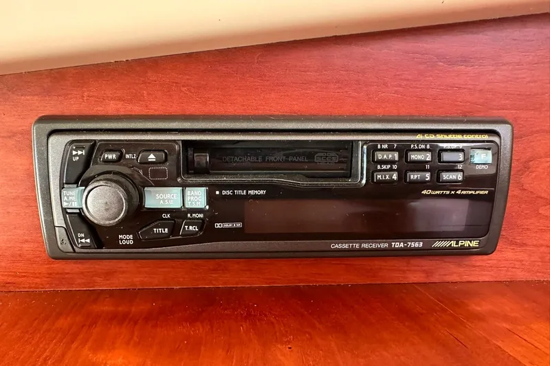 Slide: The Image of Alpine cassette receiver in a 2000 Hinckley Picnic Boat 36, mounted on wooden panel. - 22