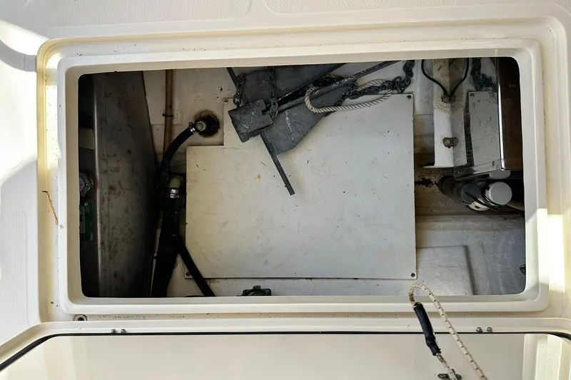 Slide: The Image of Anchor storage compartment of 2000 Hinckley Picnic Boat 36, featuring chains and ropes. - 27