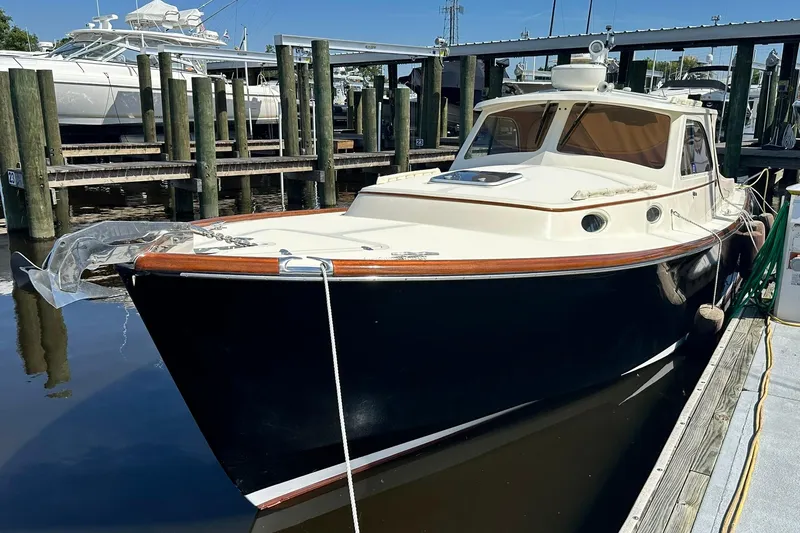 Slide: The Image of 2000 Hinckley Picnic Boat 36 docked at a marina, showcasing classic design. - 3