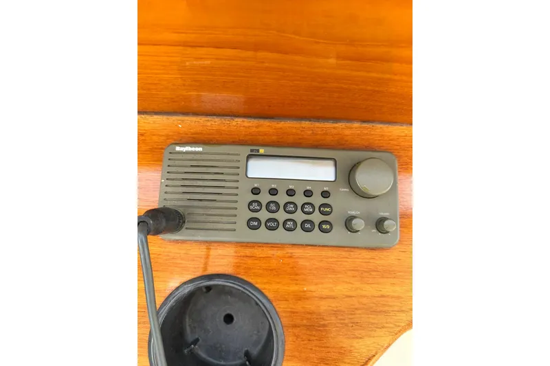 Slide: The Image of Raytheon marine radio on 2000 Hinckley Picnic Boat 36 wooden dashboard. - 35