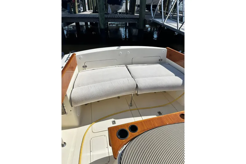 Slide: The Image of Hinckley Picnic Boat 36 (2000) with cushioned seating and wooden accents in a marina setting. - 11