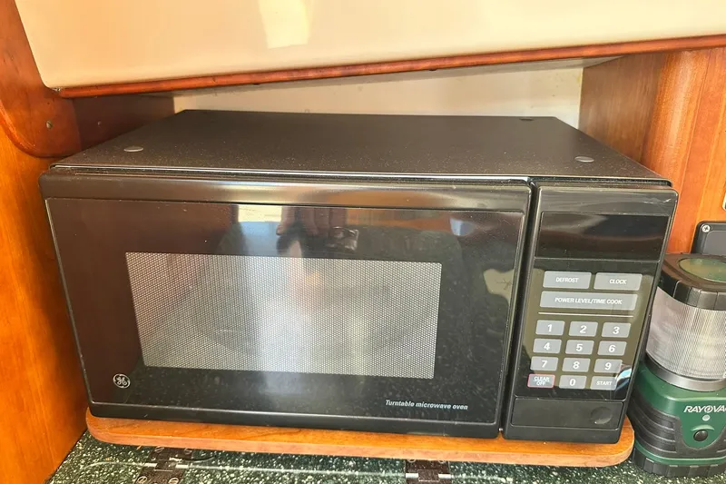 Slide: The Image of Microwave oven inside a 2000 Hinckley Picnic Boat 36, with wooden cabinetry. - 19