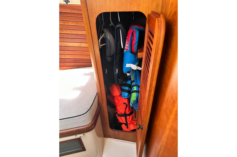 Slide: The Image of Storage compartment with life jackets on a 2000 Hinckley Picnic Boat 36. - 24