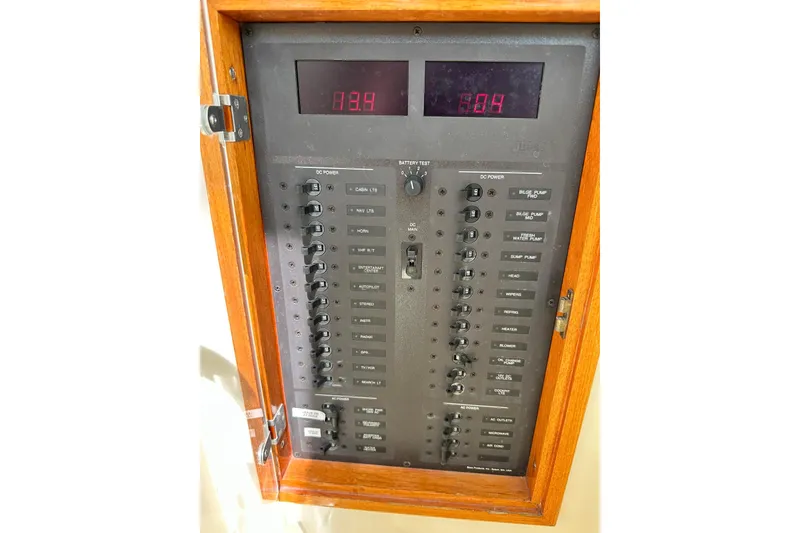 Slide: The Image of Electrical control panel on a 2000 Hinckley Picnic Boat 36, featuring switches and digital displays. - 28