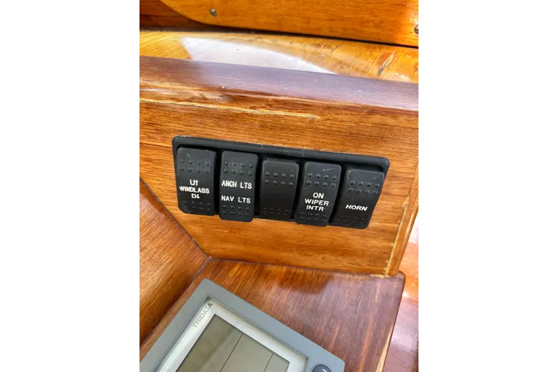 Slide: The Image of Control panel of a 2000 Hinckley Picnic Boat 36 with labeled switches. - 31