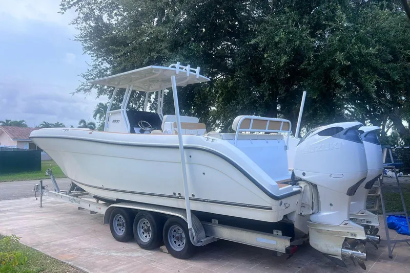 Slide: The Image of 2019 Century 3200 Center Console boat on trailer with twin Suzuki outboard engines. - 10