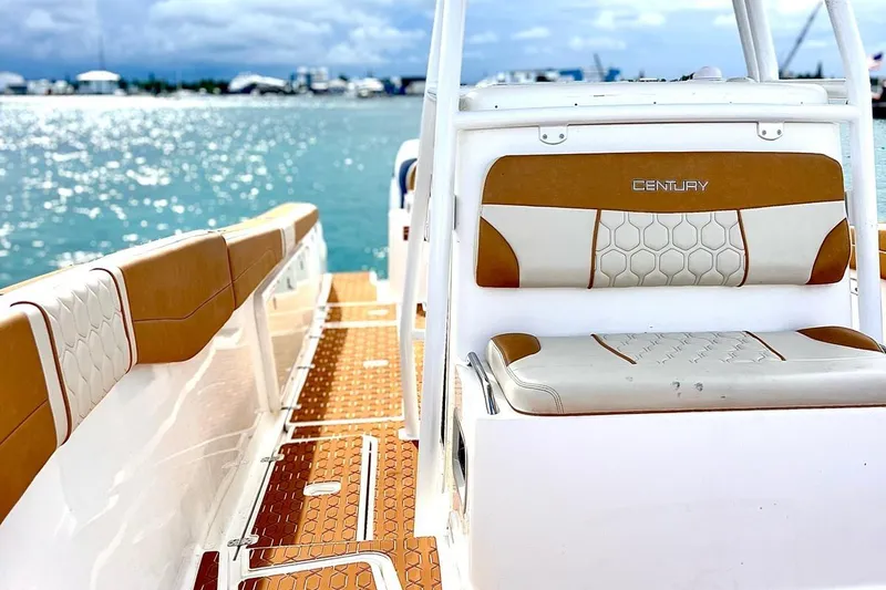 Slide: The Image of 2019 Century 3200 Center Console boat interior with tan and white seating, ocean view. - 5