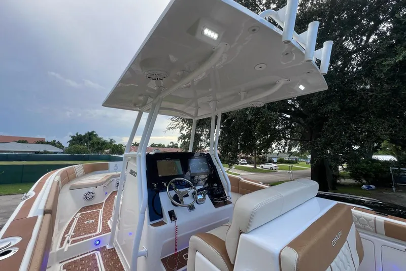 Slide: The Image of 2019 Century 3200 Center Console boat interior with helm, seating, and modern controls. - 7
