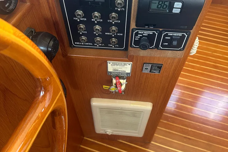 Slide: The Image of 1995 Ocean Alexander 486 Classicco Pilothouse control panel with switches and fan heater controls. - 10