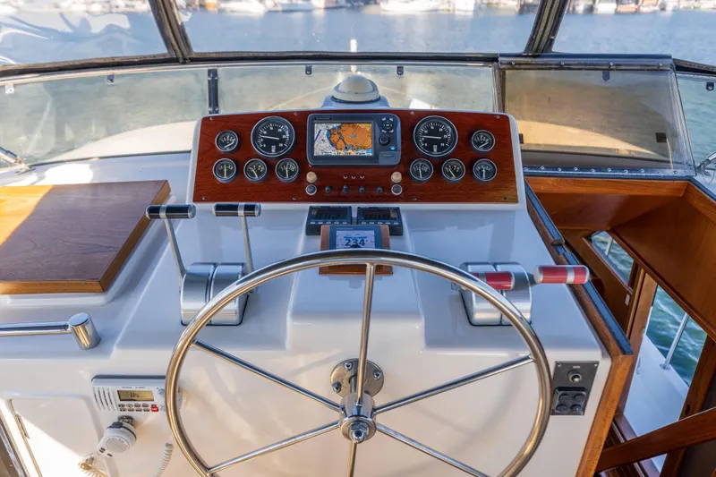 Slide: The Image of 1995 Ocean Alexander 486 Classicco Pilothouse helm with navigation instruments and steering wheel. - 13
