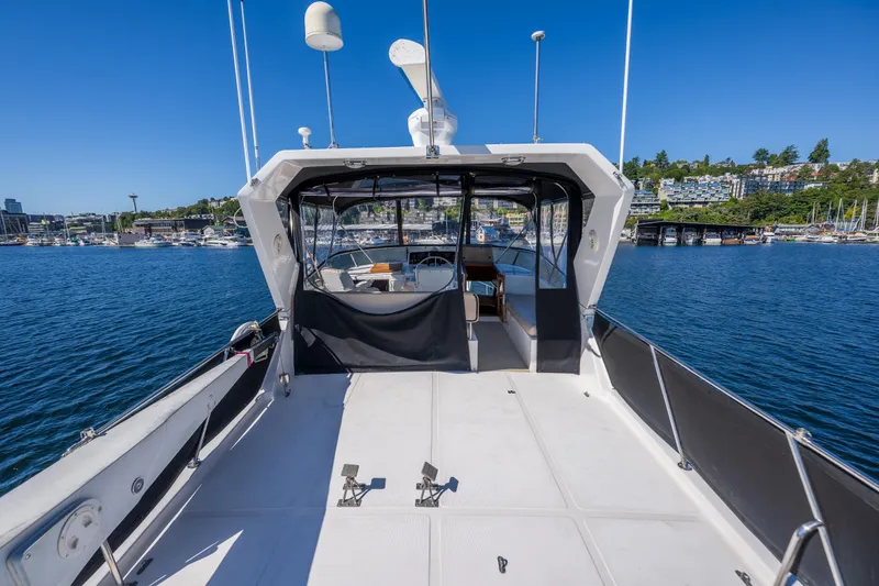 Slide: The Image of 1995 Ocean Alexander 486 Classicco Pilothouse yacht on calm water, clear sky background. - 17