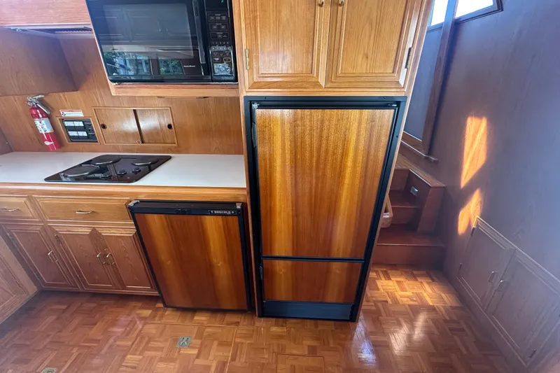 Slide: The Image of 1995 Ocean Alexander 486 Classicco Pilothouse kitchen with wood cabinetry and appliances. - 22
