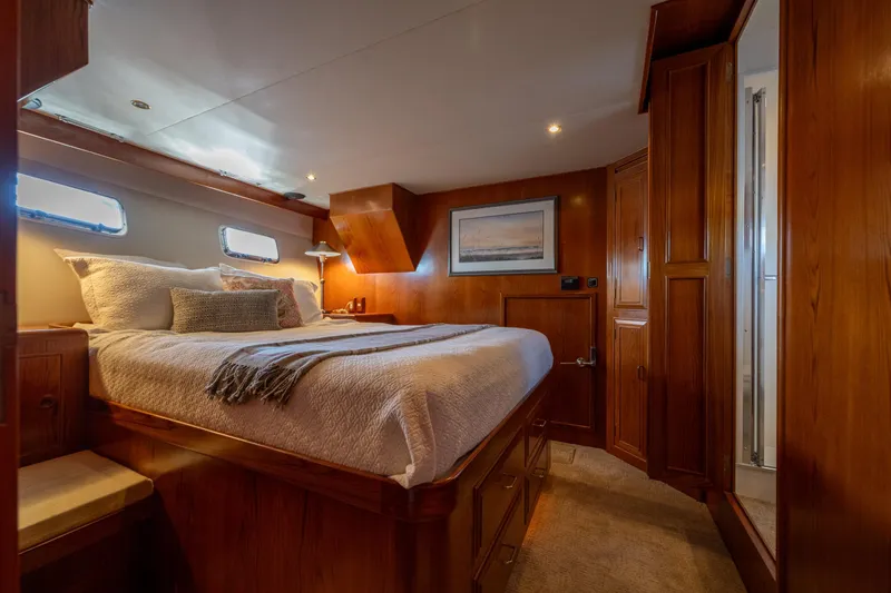 Slide: The Image of Luxurious bedroom in 1995 Ocean Alexander 486 Classicco Pilothouse yacht, featuring elegant Teakwood finishes. - 30