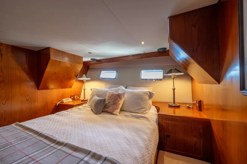Slide: The Image of Cozy bedroom in 1995 Ocean Alexander 486 Classicco Pilothouse with wood paneling and soft lighting. - 31