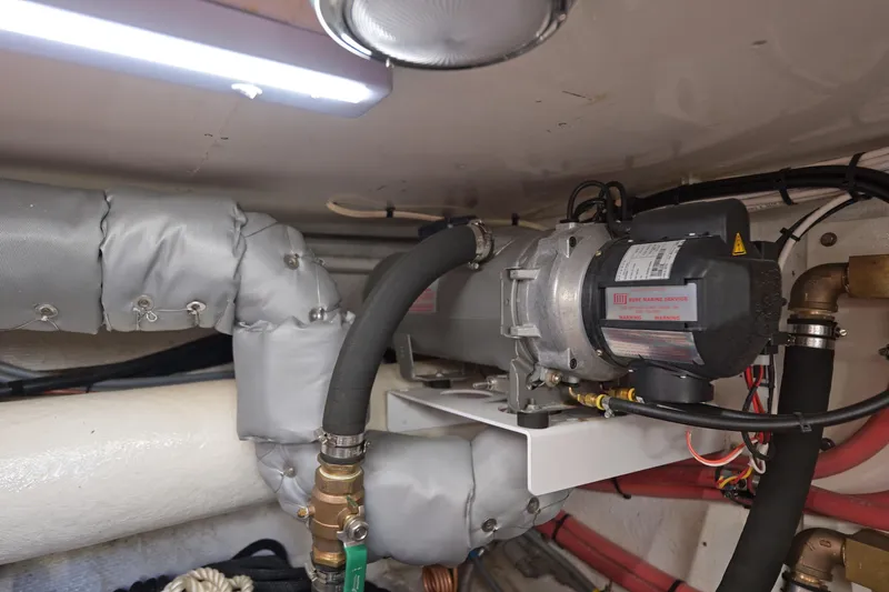 Slide: The Image of Engine room of 1995 Ocean Alexander 486 Classicco Pilothouse with insulated pipes and machinery. - 45