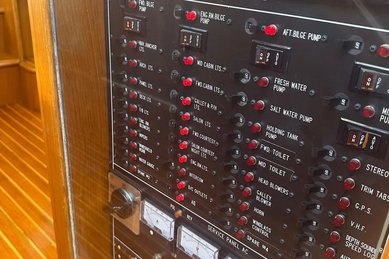 Slide: The Image of Control panel of a 1995 Ocean Alexander 486 Classicco Pilothouse yacht, featuring various switches. - 9
