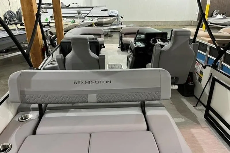 Slide: The Image of 2025 Bennington 24MSB pontoon boat interior with gray seating and steering console. - 3
