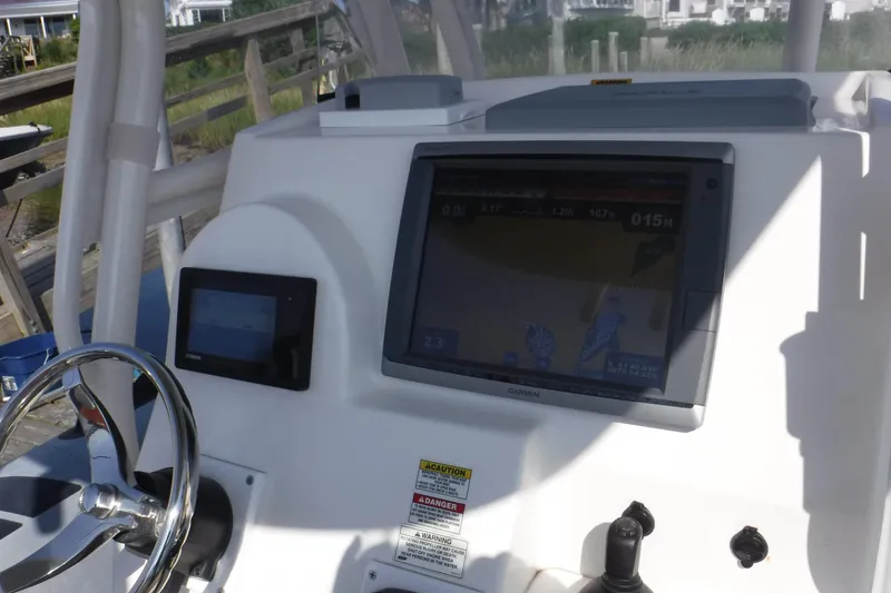 Slide: The Image of Control panel of 2015 Zodiac 28 Pro Optimum boat with navigation screens and steering wheel. - 3