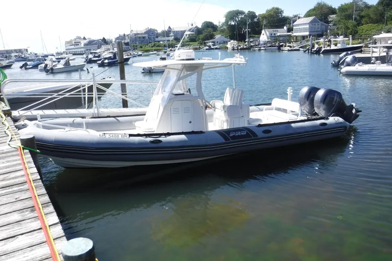 The Image of 2015 Zodiac 28 Pro Optimum boat docked in a marina with scenic background. - 0